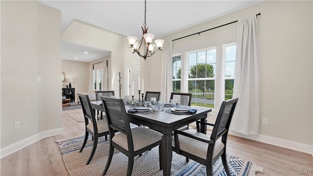 dining room featuring a notable chandelier and light wood-type flooring