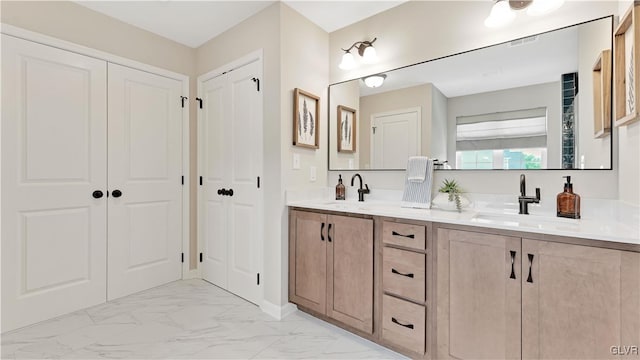 bathroom with double vanity and tile patterned flooring