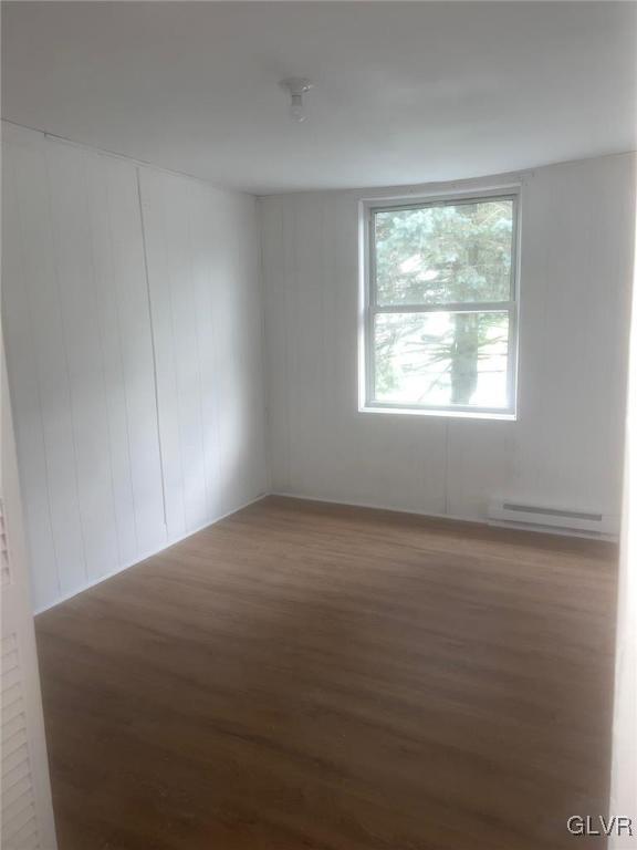 empty room featuring a baseboard radiator