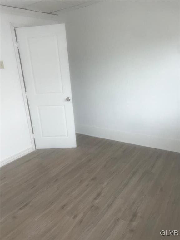 unfurnished room with dark hardwood / wood-style flooring