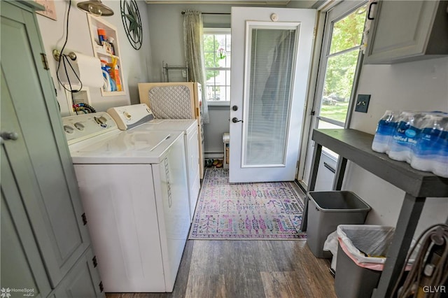 laundry room with dark hardwood / wood-style flooring, plenty of natural light, cabinets, and separate washer and dryer