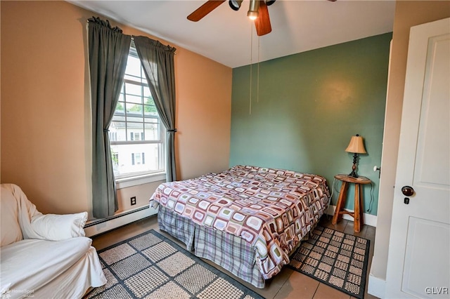 bedroom featuring a baseboard heating unit and ceiling fan