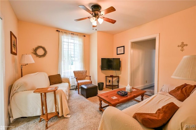 living room with ceiling fan, baseboard heating, and carpet