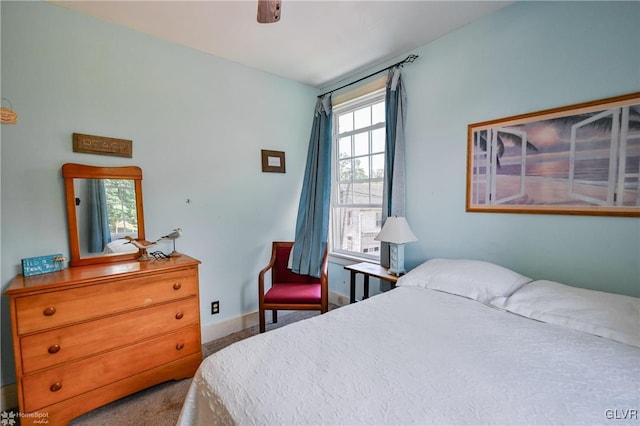 bedroom with ceiling fan and multiple windows