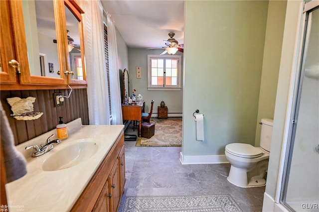 bathroom featuring ceiling fan, toilet, vanity, tile patterned flooring, and baseboard heating