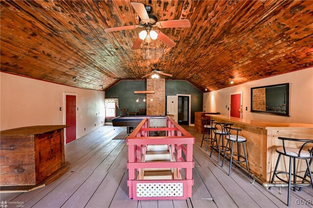 recreation room featuring ceiling fan, wood-type flooring, and vaulted ceiling