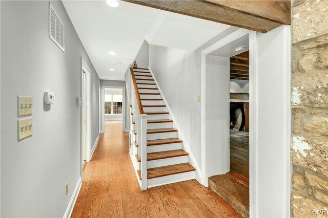 stairs featuring wood-type flooring