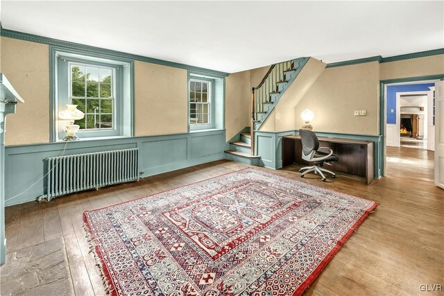 misc room with crown molding, hardwood / wood-style floors, and radiator