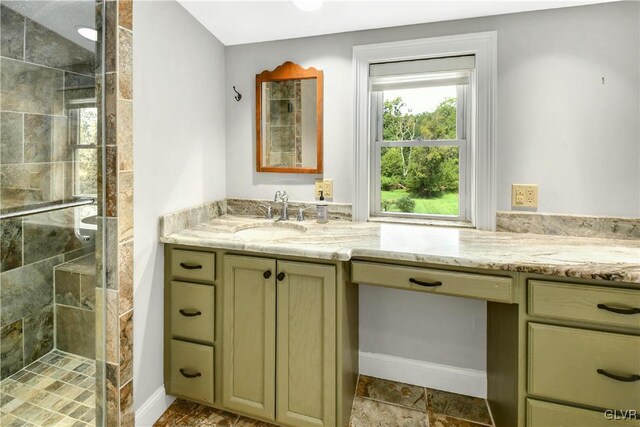 bathroom with tile patterned floors, walk in shower, and vanity