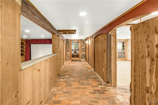 hallway with wood walls