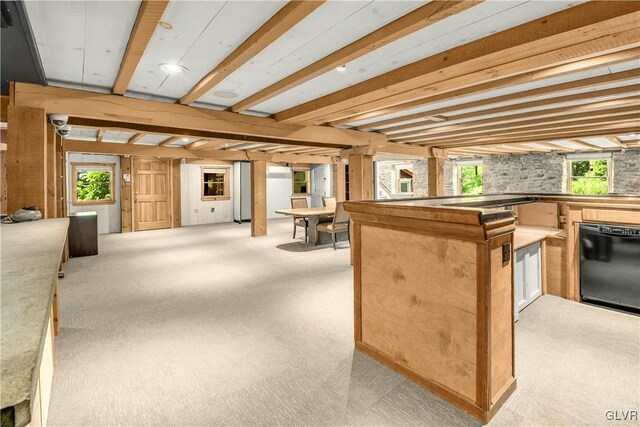 interior space with beamed ceiling, light colored carpet, refrigerator, and a healthy amount of sunlight