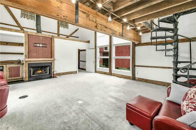 unfurnished living room with vaulted ceiling with beams, track lighting, and carpet floors