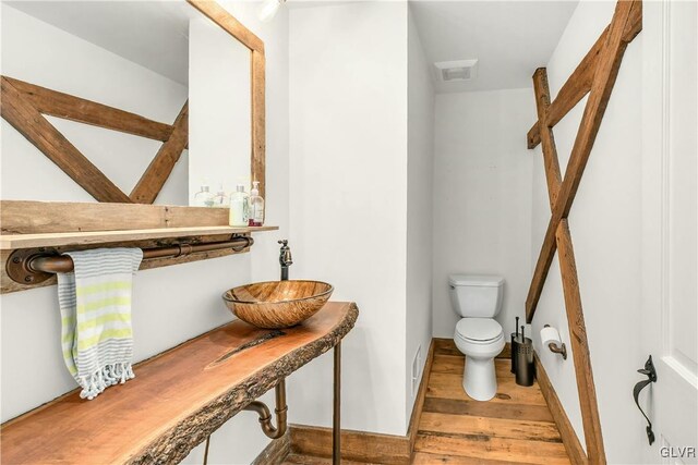 bathroom featuring sink, toilet, and hardwood / wood-style floors