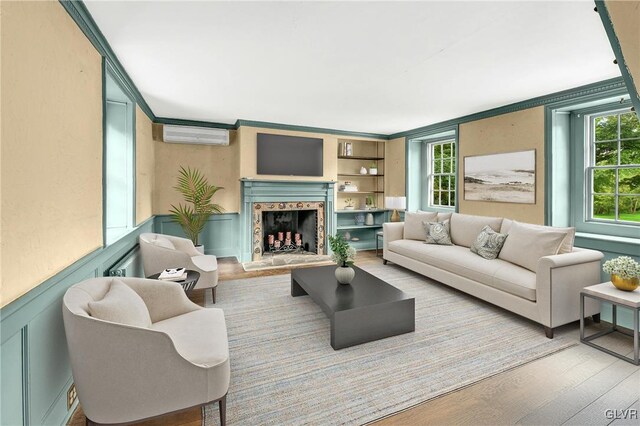 living room featuring hardwood / wood-style floors, ornamental molding, and a premium fireplace