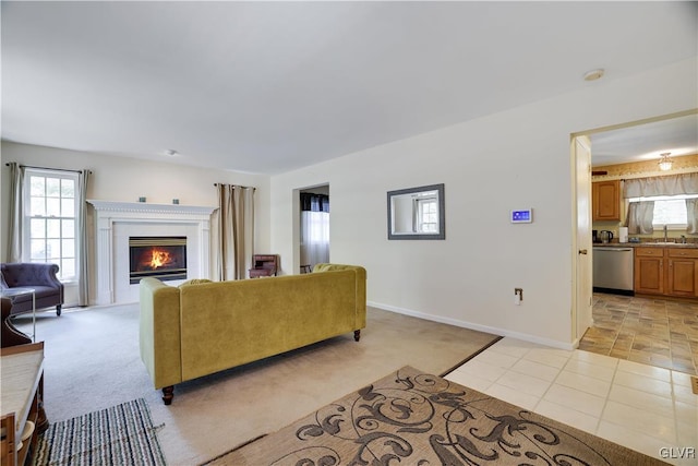 carpeted living room with sink