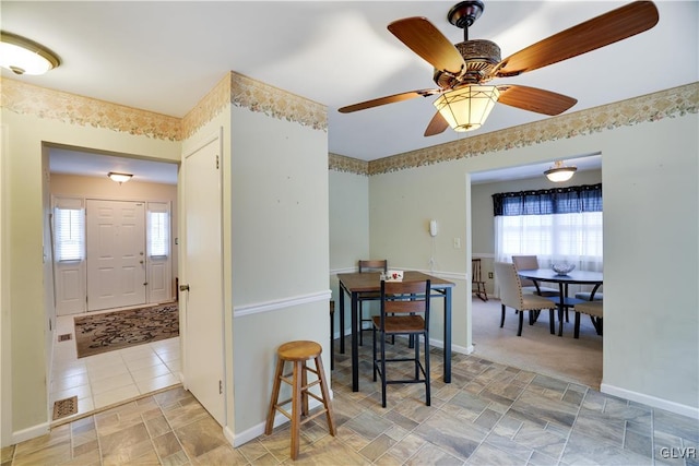 kitchen featuring ceiling fan, a healthy amount of sunlight, and light tile patterned floors