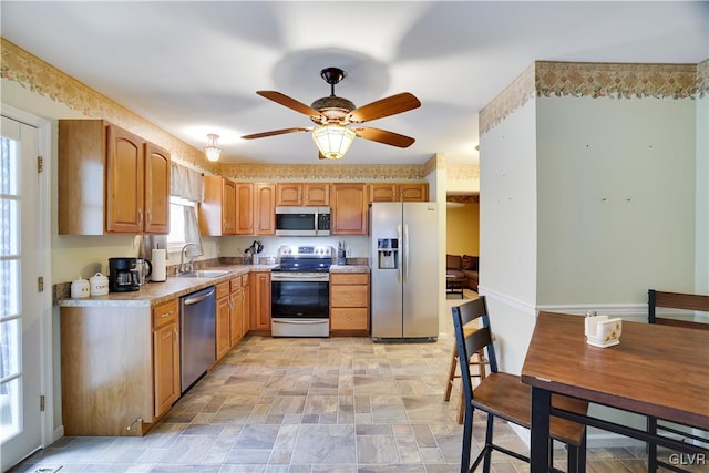 kitchen featuring sink, stainless steel appliances, ceiling fan, and light tile patterned floors