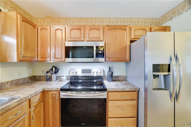 kitchen featuring stainless steel appliances and light brown cabinetry