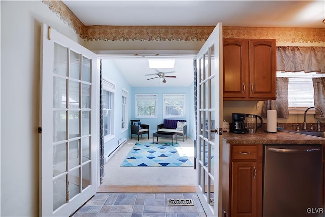 kitchen with dishwasher, sink, french doors, carpet flooring, and ceiling fan