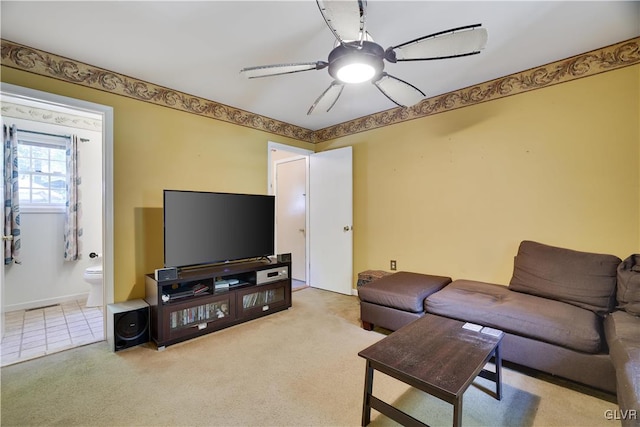 living room with ceiling fan and light carpet