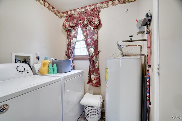 clothes washing area featuring washing machine and dryer and gas water heater