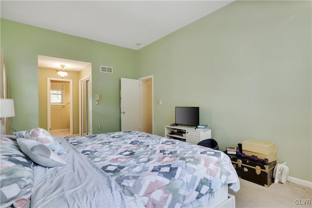 bedroom featuring carpet floors and connected bathroom