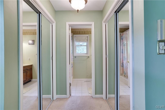 hallway featuring light carpet