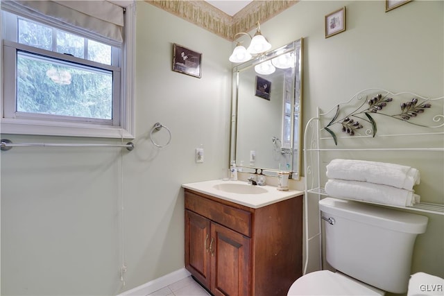 bathroom with tile patterned flooring, vanity, and toilet