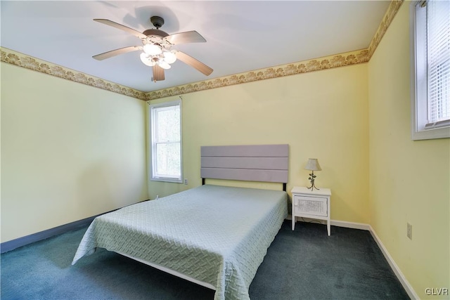 carpeted bedroom featuring ceiling fan and multiple windows