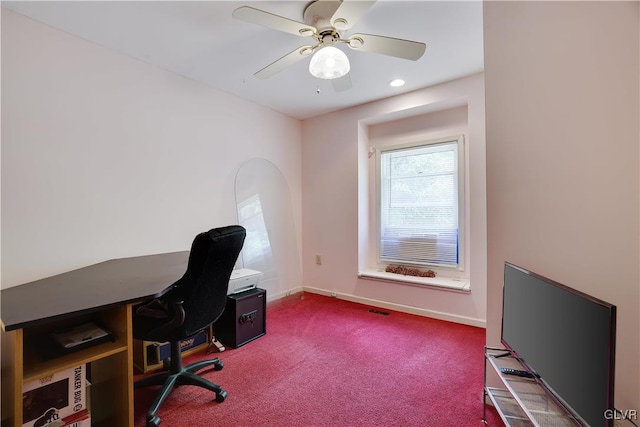 carpeted office space with ceiling fan