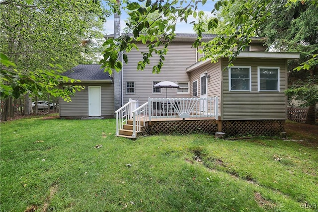 back of house featuring a yard and a deck