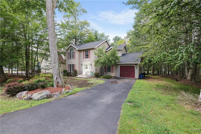 view of front facade featuring a front lawn and a garage