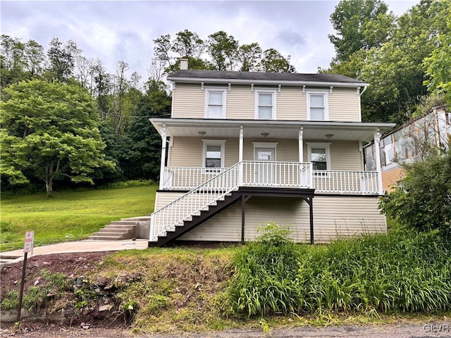 view of front of house featuring a front lawn and covered porch