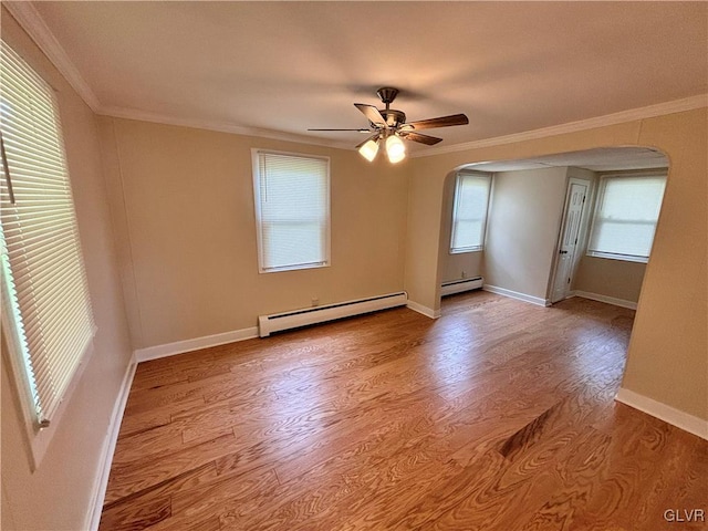 unfurnished room featuring plenty of natural light, light hardwood / wood-style flooring, and a baseboard radiator