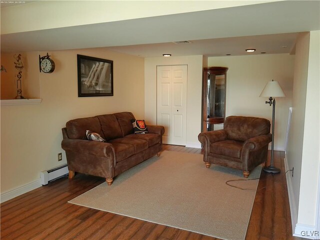 living room with a baseboard radiator and dark hardwood / wood-style floors