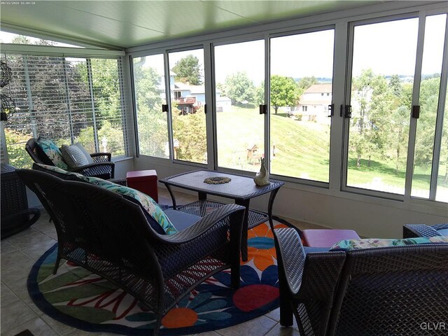 sunroom / solarium featuring plenty of natural light and lofted ceiling