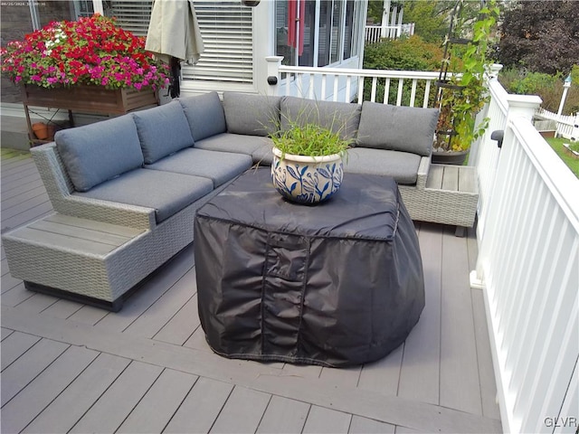 wooden deck with an outdoor living space