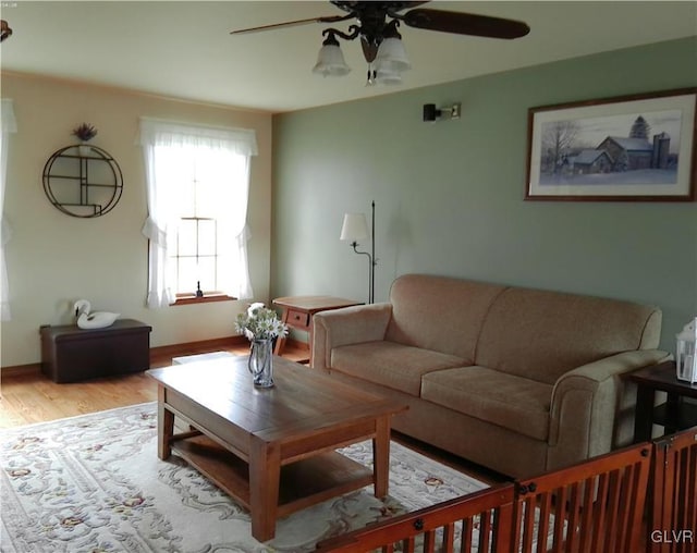 living room with ceiling fan and light wood-type flooring