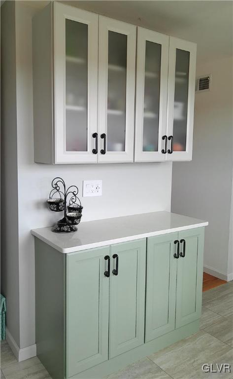 bar featuring green cabinetry