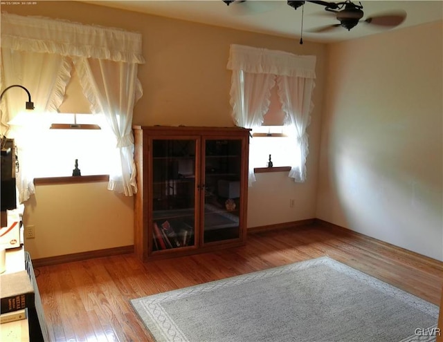 unfurnished living room featuring ceiling fan and light hardwood / wood-style floors