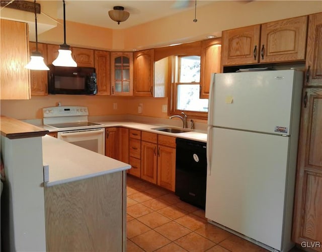 kitchen featuring light tile patterned floors, a sink, light countertops, black appliances, and decorative light fixtures