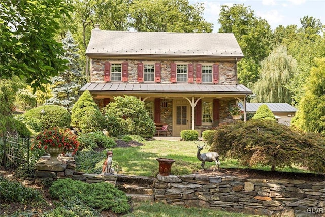 view of front of home featuring a front yard and a porch