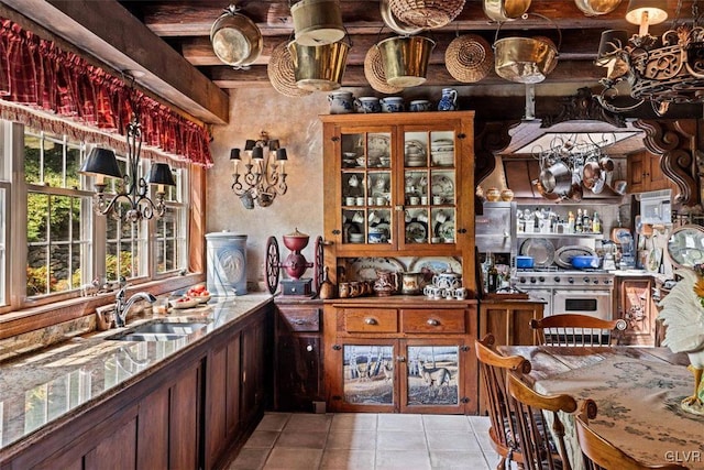 wine room featuring light tile patterned floors and sink