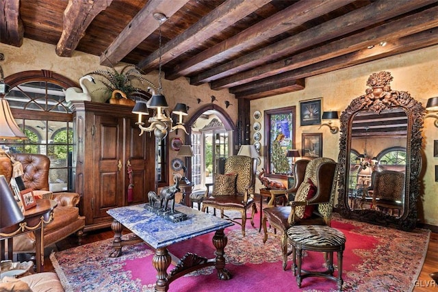 living area featuring wood ceiling, hardwood / wood-style flooring, and beam ceiling