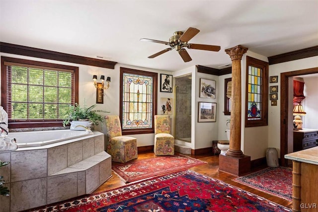 full bathroom featuring crown molding, hardwood / wood-style flooring, ornate columns, and ceiling fan