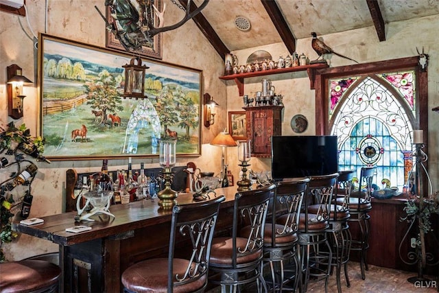 bar featuring lofted ceiling with beams