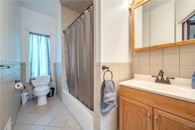 full bathroom with tile walls, vanity, and toilet