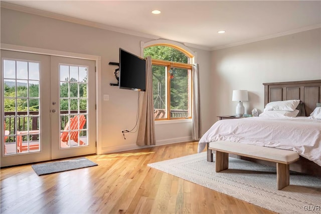 bedroom featuring light hardwood / wood-style floors, ornamental molding, french doors, and access to exterior