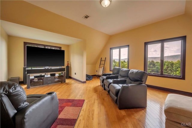 living room with light hardwood / wood-style flooring and lofted ceiling