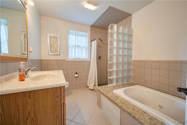 full bathroom with shower with separate bathtub, vanity, tile patterned flooring, tile walls, and toilet